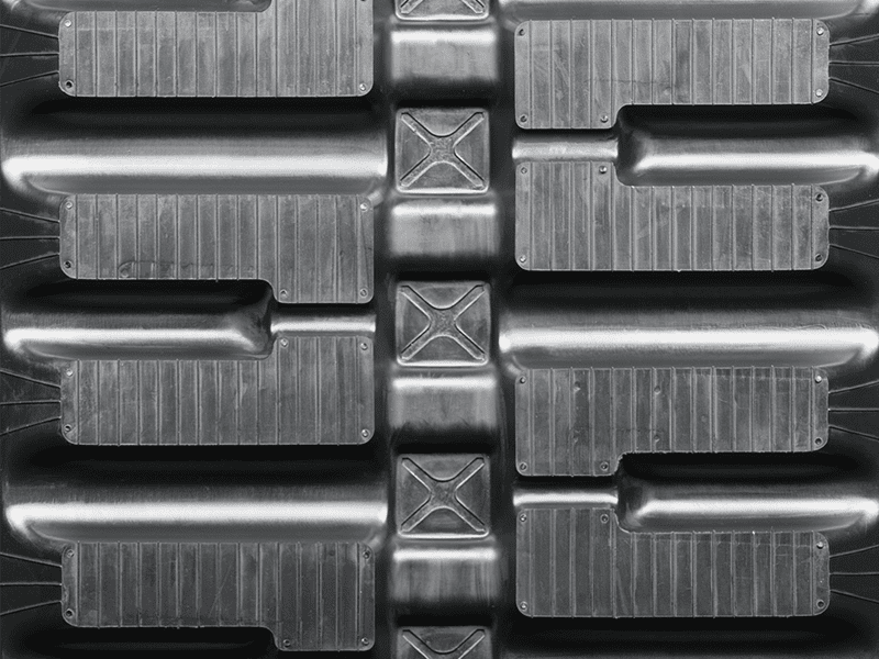 A close up of the metal tread pattern on an industrial machine.
