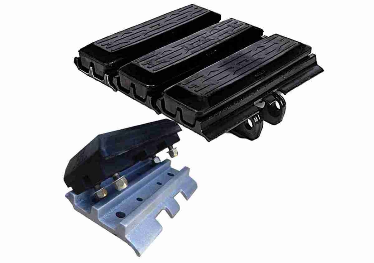 A set of three black plastic ramps next to a blue metal track.