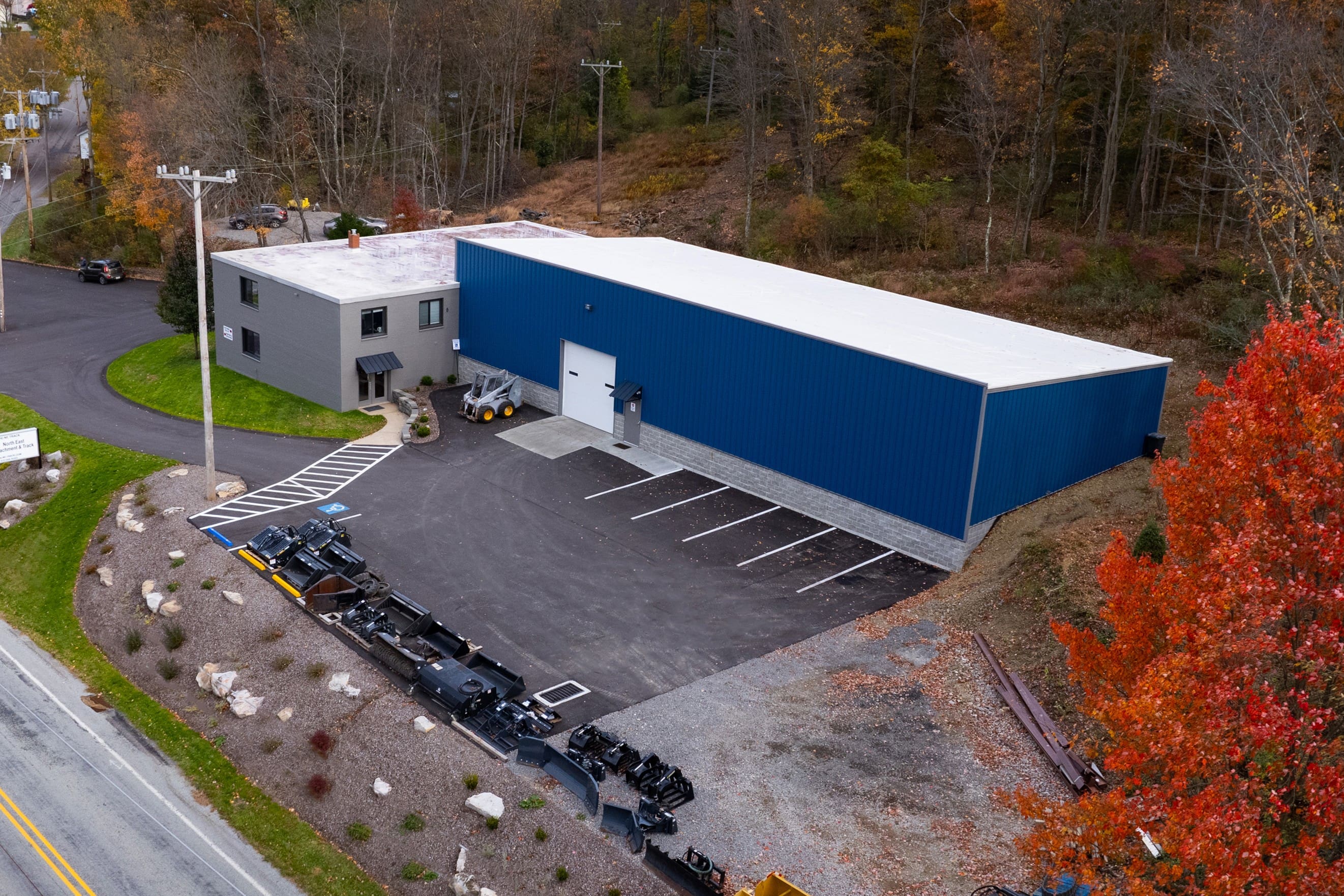A large warehouse with many cars parked in it.